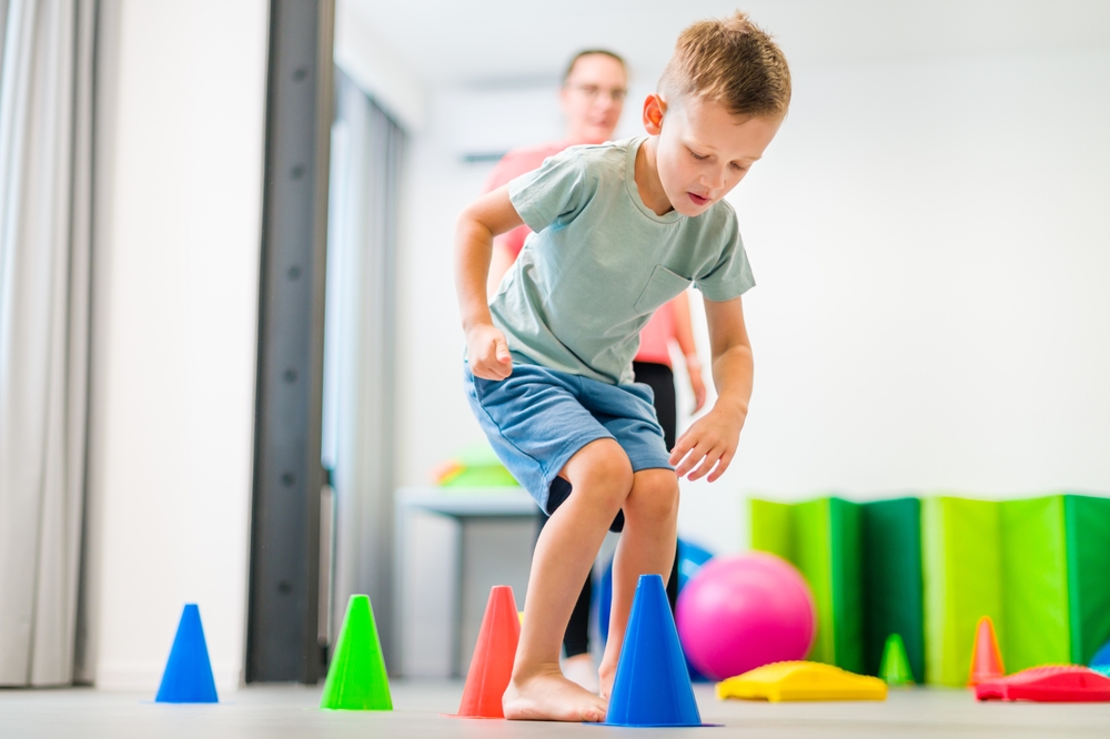 Young,Boy,Exercising,With,Female,Physical,Therapist,During,Therapy,Session.
